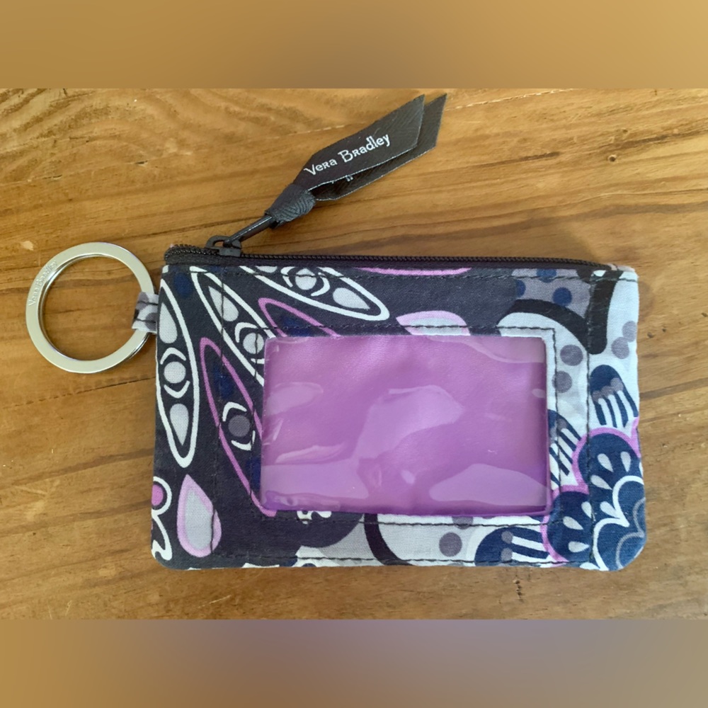 Vera Bradley 
ID window
Interior compartment
Key ring
Zip closure